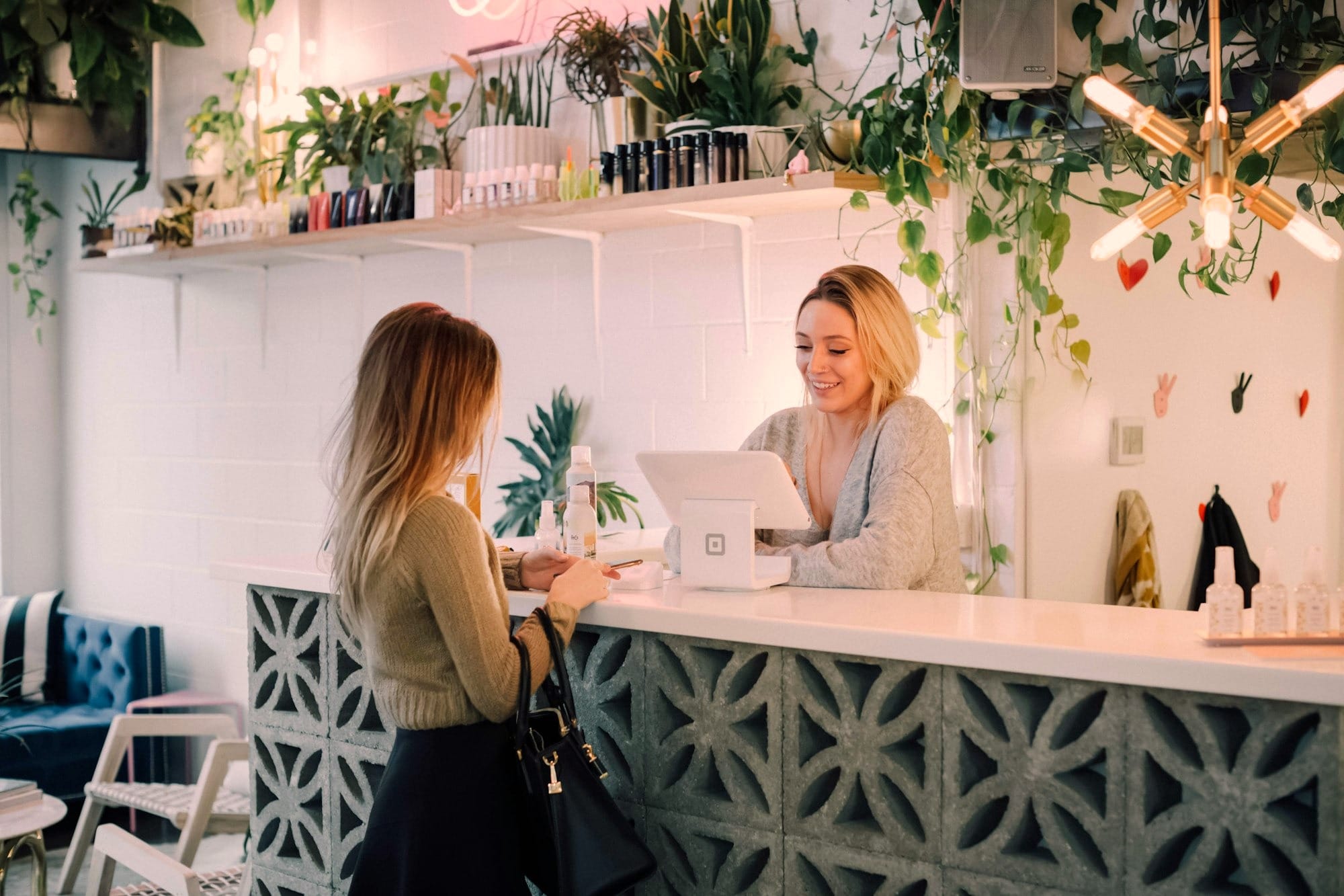 woman facing reception counter indicating that the soul of any system is in the first five seconds of a customer's experience