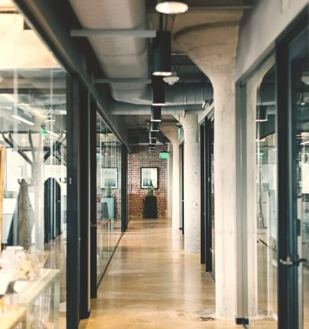 architectural photography of a hallway within a white concrete office building
