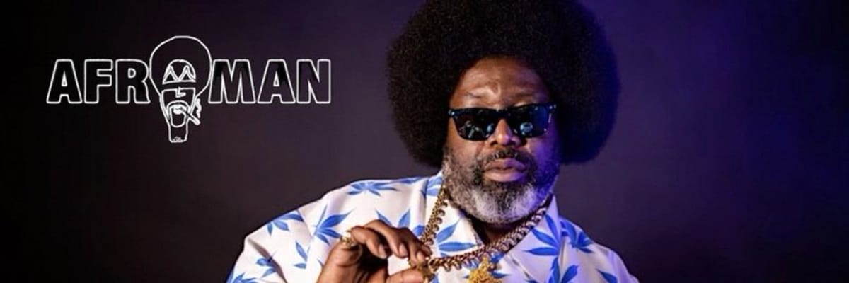 Afroman in sunglasses and a blue-and-white patterned shirt, posed against a dark background in a promotional profile image.